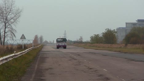 A-bus-passes-on-an-abaondoned-road-near-the-Chernobyl-nuclear-power-plant
