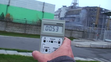 A-person-holds-up-a-Geiger-counter-to-read-radiatiopn-near-the-Chernobyl-nuclear-meltdown