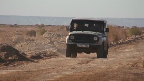 An-old-jeep-passes-on-a-road-near-the-Aral-Sea-in-Kazakhstan-or-Uzbekistan