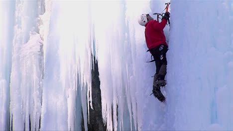 Close-up-of-a-man-climbing-a-frozen-waterfall