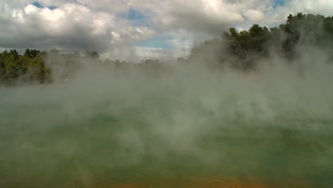 Steam-rises-off-a-geothermal-lake-in-New-Zealand's-Rotorua-region