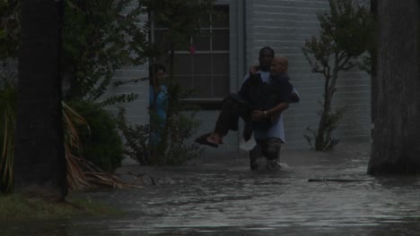 A-man-rescues-a-elderly-citizen-from-flooding-during-a-big-storm