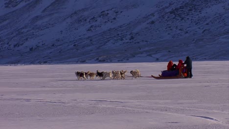 An-eskimo-dogsled-heads-across-the-frozen-tundra-in-the-distance-2