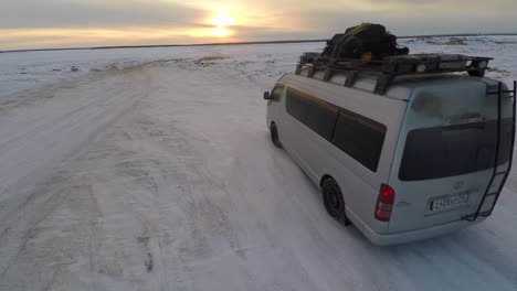 Aerial-as-a-truck-drives-across-frozen-tundra-in-the-Russian-Arctic-in-Siberia