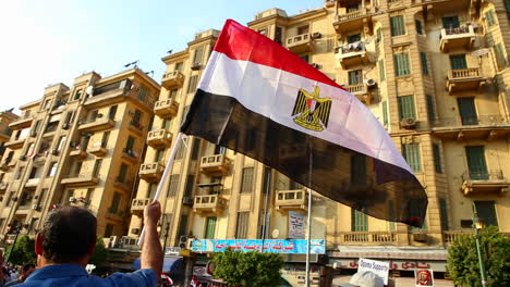 The-sun-shines-through-a-protestor's-flag-in-Cairo-Egypt