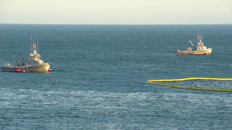 Emergency-Boats-Lay-Out-A-Protective-Net-After-The-Massive-Beach-Cleanup-Effort-Following-The-Refugio-Oil-Spill-1