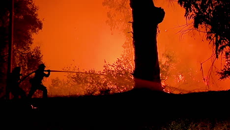 A-Firefighter-Stands-In-Silhouette-And-Fights-A-Huge-Hillside-Blaze-During-The-Holiday-Fire-1