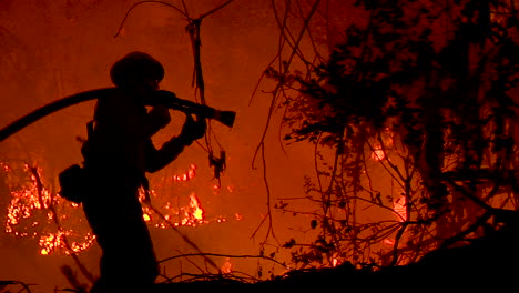 A-Firefighter-Stands-In-Silhouette-And-Fights-A-Huge-Hillside-Blaze-During-The-Holiday-Fire-In-Goleta-California