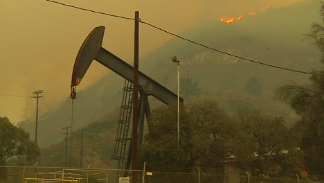 The-Hills-Behind-An-Oil-Derrick-Between-Ventura-And-Santa-Barbara-Burn-During-The-Thomas-Fire