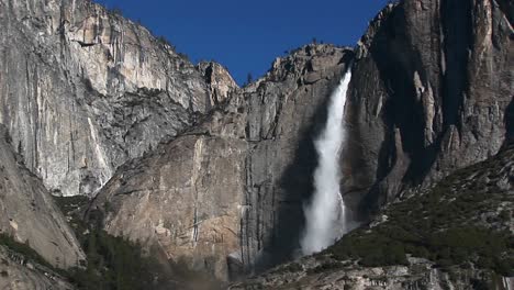 Steep-Rocky-Mountains-Feature-A-Spectacular-Waterfall-And-Spray-As-It-Plummets-To-The-Bottom