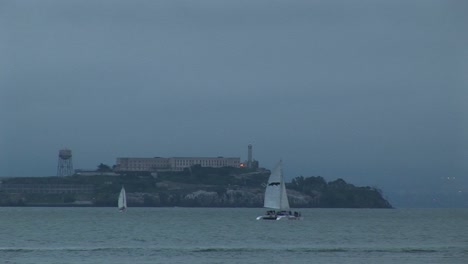 Medium-Shot-Of-A-Catamaran-Moving-Past-Historic-Alcatraz-Island-Opposite-San-Francisco