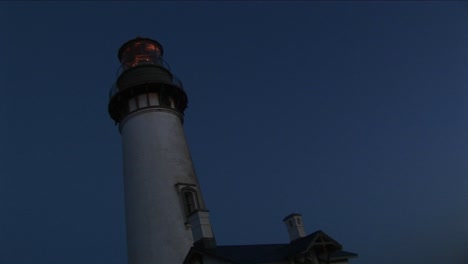 A-Wormseye-View-Of-A-Lighthouse-Tower-And-Beacon-At-Night