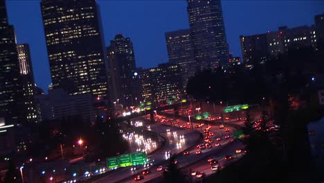 A-Closeup-Of-Downtown-Seattle-Buildings-With-Heavy-Traffic-Flowing-Along-Major-Expressways