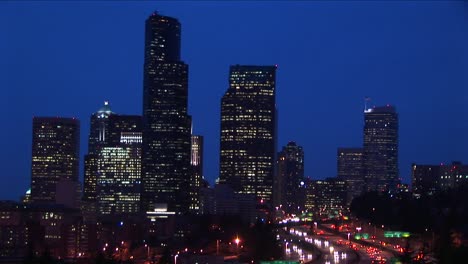 Long-Shot-Of-A-Group-Of-Seattle'S-Skyscrapers-Towering-Above-An-Innercity-Expressway