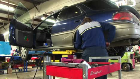 A-Mechanic-Uses-A-Wrench-To-Work-On-The-Wheelmount-Of-An-Auto-On-A-Hydraulic-Lift