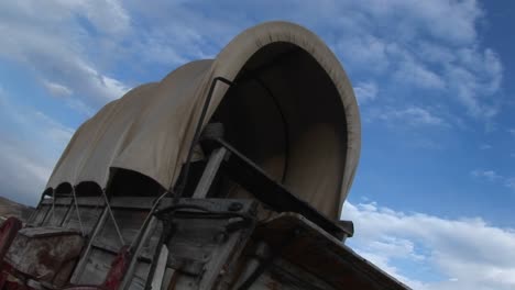 Wormseye-View-Of-A-Covered-Wagon-Against-A-Blue-Sky