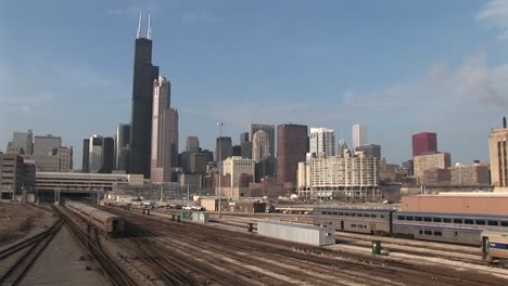 A-Commuter-Train-Passes-Through-This-Long-Shot-Of-Chicago'S-Skyline-And-Skyscrapers