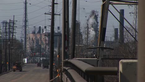 An-Innercity-Industrial-Area-With-Refineries-Utility-Wires-Smoke-And-Traffic