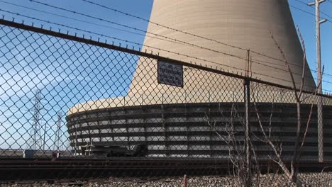 The-Camera-Pans-From-The-Base-Of-A-Nuclear-Power-Plant-To-The-Top-Of-Its-Curved-Structure