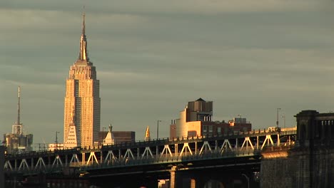 The-Empire-State-Building-Rises-Above-The-Surrounding-Buildings-And-Freeway-In-The-Foreground