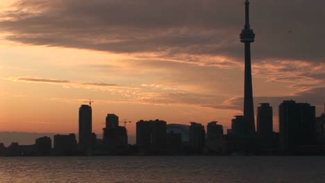 A-Spectacular-Sunset-With-The-Cntower-And-Other-Buildings-Nearby-Silhouetted-Against-The-Colorful-Sky