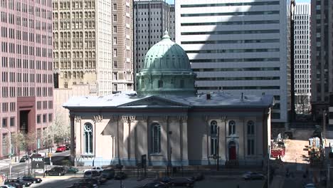 A-Charming-Domed-Building-Is-Dwarfed-By-The-Surrounding-Skyscrapers-In-This-Downtown-Shot