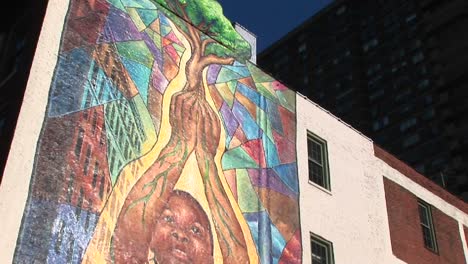 Camera-Pans-Up-To-Reveal-A-Colorful-Mural-On-An-Innercity-Building'S-Exterior