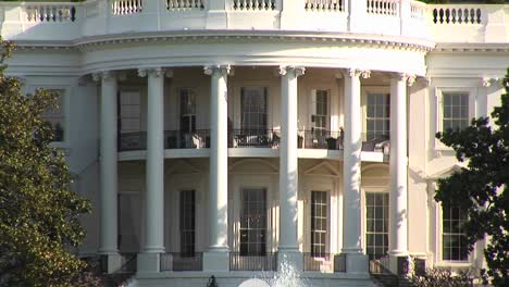 The-Camera-Pans-Up-To-Show-Several-People-Walking-On-The-Second-Floor-Balcony-Of-The-White-House