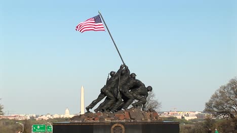 The-Iwo-Jima-Marine-Corps-Memorial-Stands-Tall-With-The-Washington-Monument-Faintly-In-The-Background
