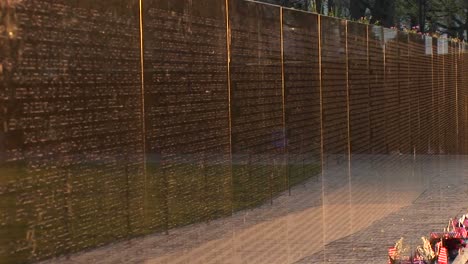 Close-Up-Of-The-Vietnam-Veterans-Memorial-Wall-With-Tributes-And-Mementos-In-Front