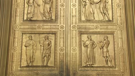 Close-View-Of-The-Historic-Figures-Carved-Into-The-Bronze-Doors-At-The-West-Entrance-Supreme-Court