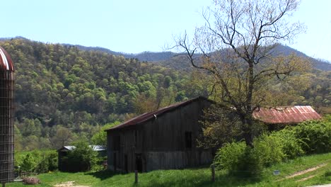 A-Country-House-And-Barn-Sit-Surrounded-By-Beautiful-Mountain-Scenery