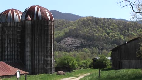Large-Grain-Silos-And-The-Surrounding-Mountains-Dominate-The-Landscape-Of-This-Rural-Farm