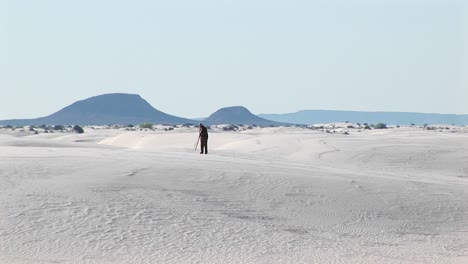 Longshot-Of-A-Photographer-Setting-Up-A-Tripod-In-White-Sands-National-Monument-In-New-Mexico