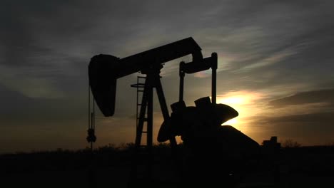 Medium-Shot-Of-A-Silhouetted-Oil-Pump-Turning-In-The-New-Mexico-Desert