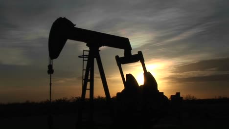 Medium-Shot-Of-A-Silhouetted-Oil-Pump-Turning-In-The-New-Mexico-Desert-1