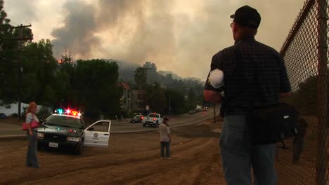 Medium-Shot-Of-Emergency-Personnel-Viewing-A-Wildfire-From-A-Town-In-California