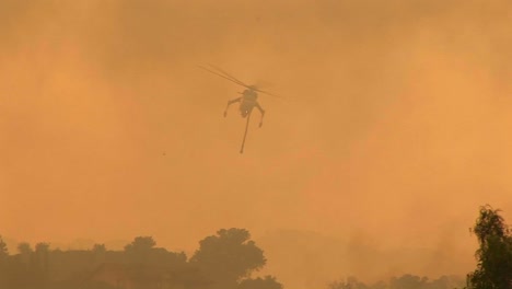 Following-Shot-Of-A-Helicopter-Dropping-Chemicals-On-A-Wildfire-In-California-1
