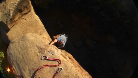 Aerialshot-Of-A-Rock-Climber-Climbing-Up-A-Cliff-Face