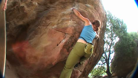 Fisheye-Shot-Of-A-Woman-Climbing-A-Rock-Wall