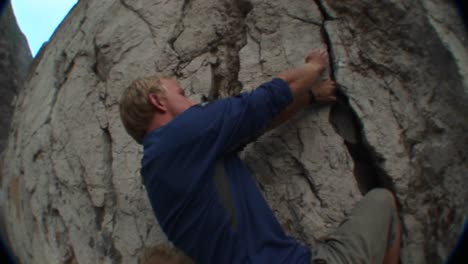 Followingshot-Of-A-Rock-Climber-Scaling-A-Cliff-Face