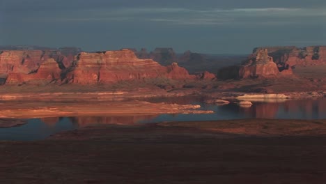 Wide-Shot-Of-Lake-Powell-And-Luminous-Surrounding-Shoreline-With-Sandstone-Cliffs