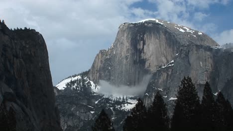 Medium-Wide-Shot-Of-Yosemite'S-Half-Dome-Hosting-Clouds-And-Winter-Snow