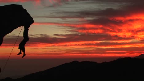Mediumshot-Of-A-Rockclimber-Silhouetted-By-A-Fiery-California-Settingsun