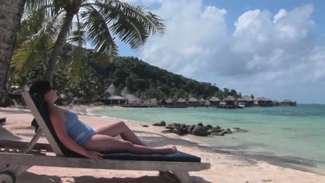 A-woman-relaxes-on-a-beach-chair