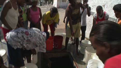 People-get-water-from-a-well-following-a-massive-earthquake-in-Haiti