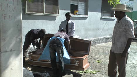 A-victim-of-the-Haiti-earthquake-is-loaded-into-a-coffin
