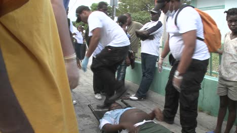 A-victim-is-moved-from-a-stretcher-during-the-earthquake-in-haiti