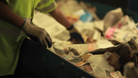 A-worker-sorts-paper-products-at-a-recycling-center