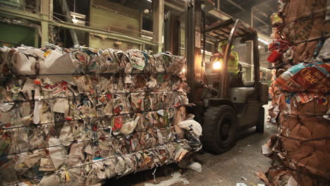 A-skip-loader-moves-pallets-of-recycled-materials-in-a-factory